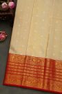 Kancheepuram Silk Cream Saree With Peacock Buttis Body And Contrast Florals And Leaves Border