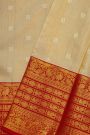 Kancheepuram Silk Cream Saree With Peacock Buttis Body And Contrast Florals And Leaves Border