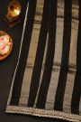 Fancy Kora Black Saree With Florals In Lines Body And Self Design Florals And Leaves In Zardozi Work Border