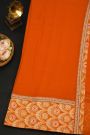 Fancy Crepe Orange Saree With All Over Plain Body And Self Design Florals And Leaves In Zari Border