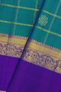 Kancheepuram Silk Peacock Blue Saree With Florals In Zari Checks Body Gap Border