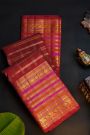 Kancheepuram Silk Maroon Saree With Florals And Peacocks In Checks Body And Self Zig-Zag Lines And Florals Border