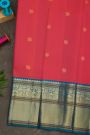 Kancheepuram Silk Coral Saree With Florals And Peacock Buttis Body