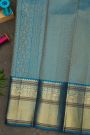 Kancheepuram Silk Coral Saree With Florals And Peacock Buttis Body