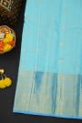 Kancheepuram Silk Sky Blue Saree With Zari Checks Florals And Peacocks Border