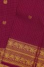 Kancheepuram Silk Magenta Saree With Zari Checks Floral And Peacock Buttis Body